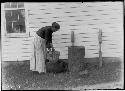 Mrs. Thomas Silverheels (Seneca) washing corn