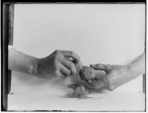 Hands illustrating Eskimo method of fire-making with pyrites