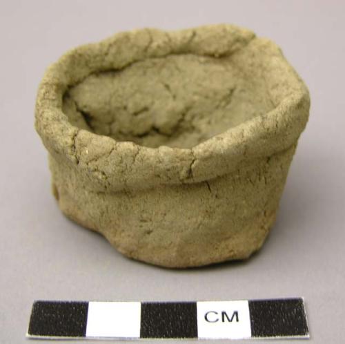 Unfired clay figurine depicting cooking vessel