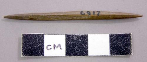 Small slender tool of bone pointed at each end