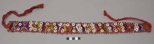 Red headband (ciklas)- worn by men & women during ceremonies