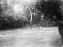 Men crossing river using rope