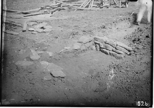 Grave showing end walls in gravel under clay