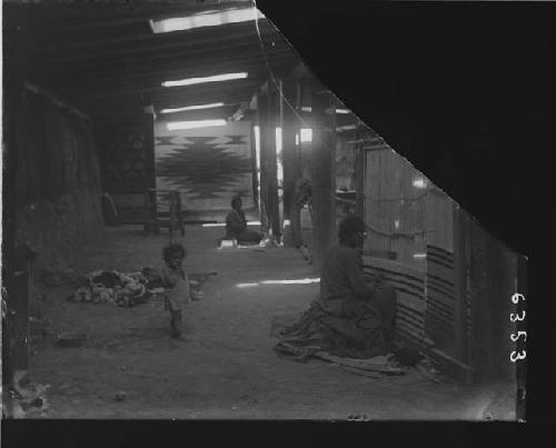 Navajo woman and children in blanket hogan