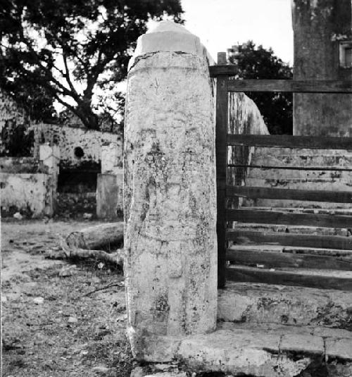 Carved pillar to left of gate of main house