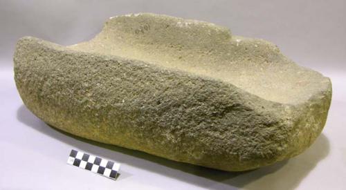 Metate. open-ended, fairly deep trough metate. rounded sides, somewhat flattened