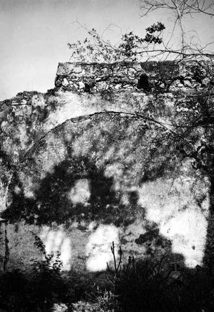 Wall of ruined church with reused sculptured stones