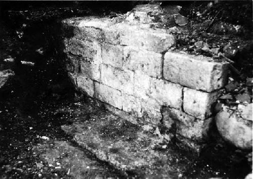 Classic Maya masonry wall showing corner and base, back of Maria Escobar's house