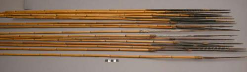 18 bamboo arrows - carved and raffia wrapped tips, white paint on base of tips (