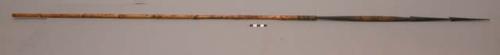 Long spear with dark wooden point of 2 circular pyramids and designs +