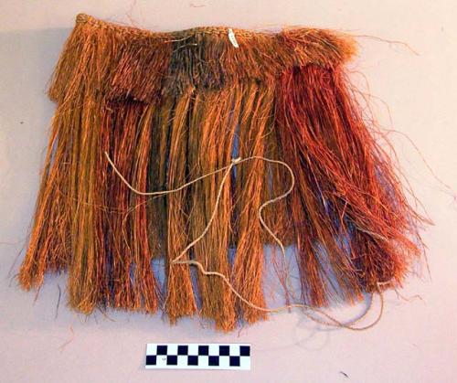 Apron of red and yellow fibre