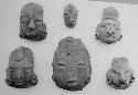 Figurine heads (6), red-brown, unslipped