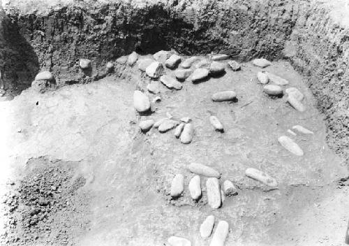 Grave excavation 3-31 showing exposed stones and floor