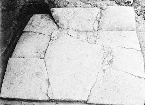 Grave 1E.  From floor of pit, looking north, showing stone cover.