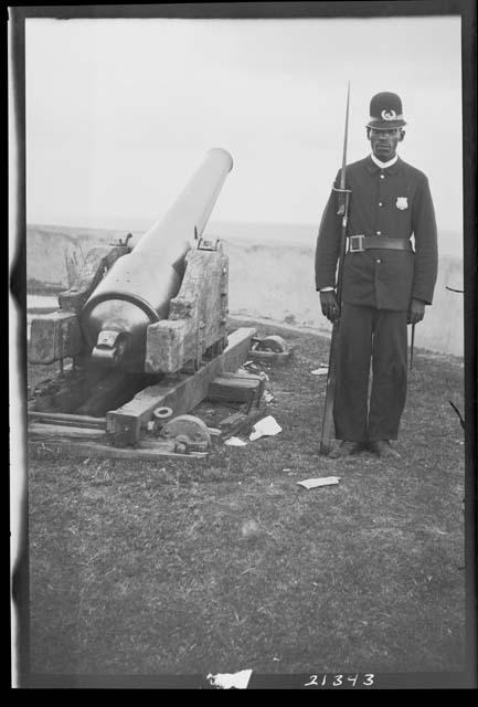 Man standing next to cannon