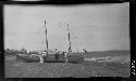 Men fixing boat in rural setting