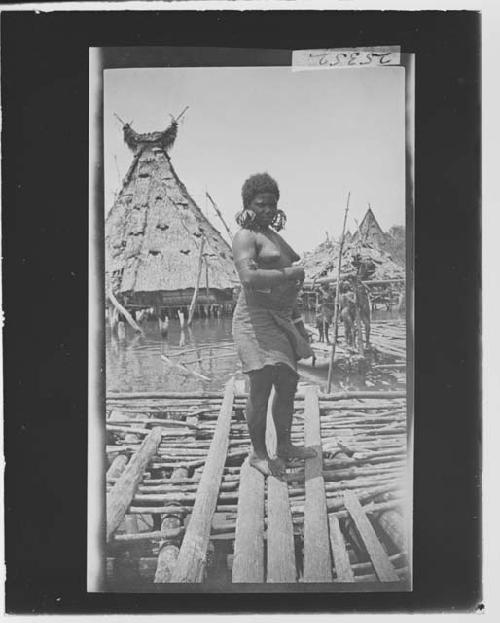 Woman in front of hut