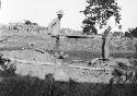 Two men showing method 2 of screening or sifting grave fill