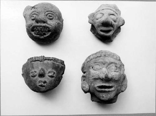 Pottery heads (4), human and tiger