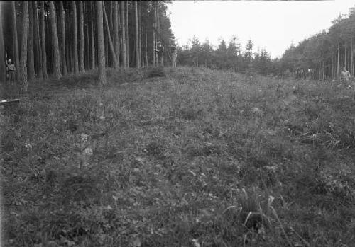 Men measuring contours of false tumulus