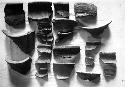 Coarse gray unslipped rim sherds (jars) with Robert's type numbers
