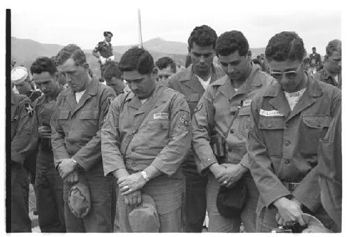 Soldiers bow their heads during Memorial Day ceremony