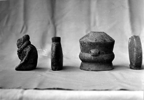 Pottery figure (107), bottles (108, 109); center vessel (110).