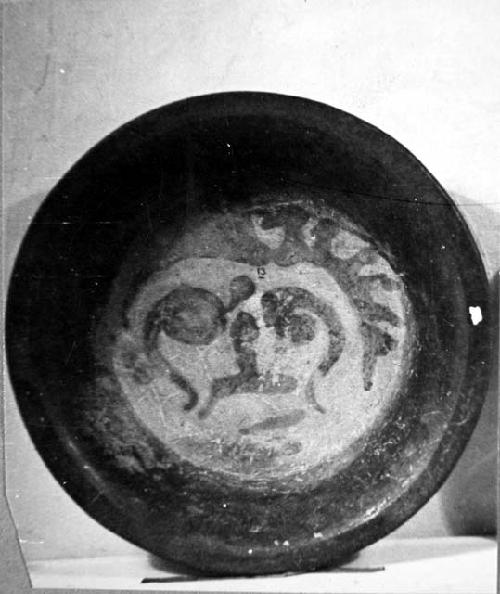 Ceramic bowl, tripod, painted anthropomorphic? face at interior