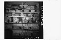 Shelf of sculptured fragments mainly from Mound 22 and Mound 26 in Peabody Museum, 1940