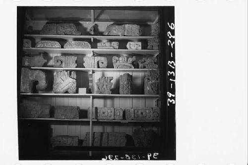 Shelf of sculptured fragments mainly from Mound 22 and Mound 26 in Peabody Museum, 1940