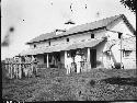 Two men in front of house in rural setting