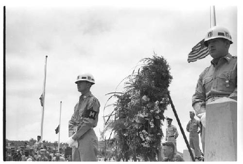 Soldiers standing around wreath