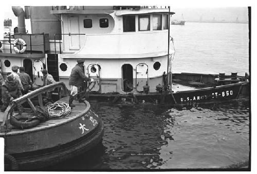 Tugboat preparing to assist with raising of another partially submerged U.S. Army tugboat