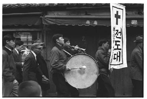 Korean Christian Evangelist marching band on street, bass drum in center