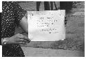 Woman holding sign Pictures by Roger Marshutz 117 So Fuller Ave Los Angeles·