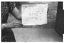 Woman holding sign Pictures by Roger Marshutz 117 So Fuller Ave Los Angeles·