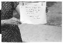 Woman holding sign Pictures by Roger Marshutz 117 So Fuller Ave Los Angeles·