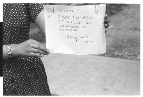 Woman holding sign Pictures by Roger Marshutz 117 So Fuller Ave Los Angeles·