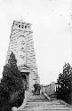 Two men standing on stairs leading up to a tower