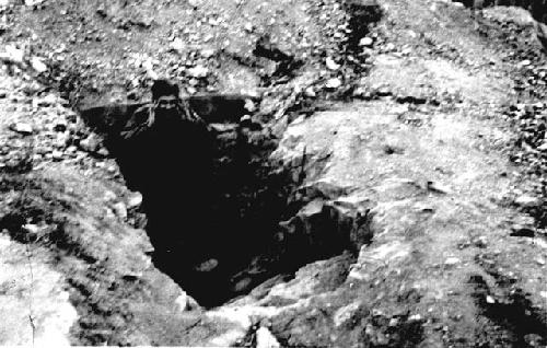 Man standing in hole in the ground