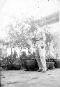 Man posing with potted trees