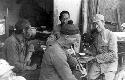 Men at table with soup and pipes