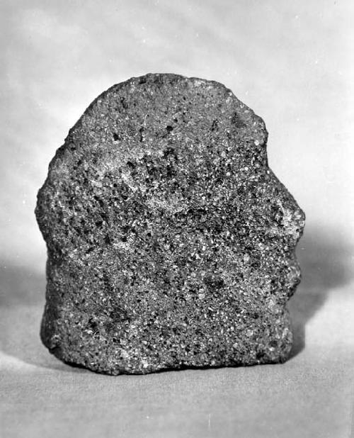 Crude stone sculpture (reused mano), vesicular.  gray lava.