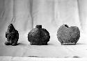Pottery figure (107), bottles (108, 109); center vessel (110).