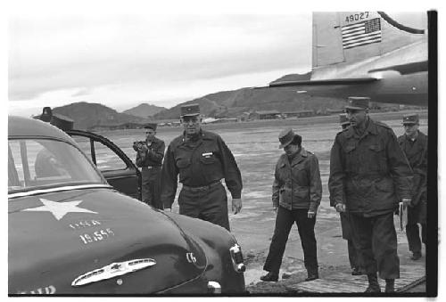 General Whitcomb and other American military personnel approaching car marked with a star and the text "U.S.A. 191555"