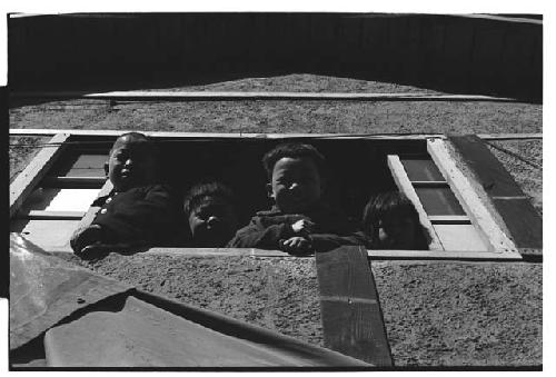 Children looking down from window