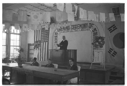 Man at podium w/ four men in front of him at U.S. Information Centre, Tong Yung