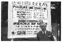 Man standing in front of sign