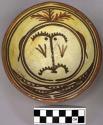 Bowl, polacca polychrome style c. int: clown design; ext: slipped, no design. 6.