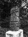 Pedestal sculpture of seated human figure